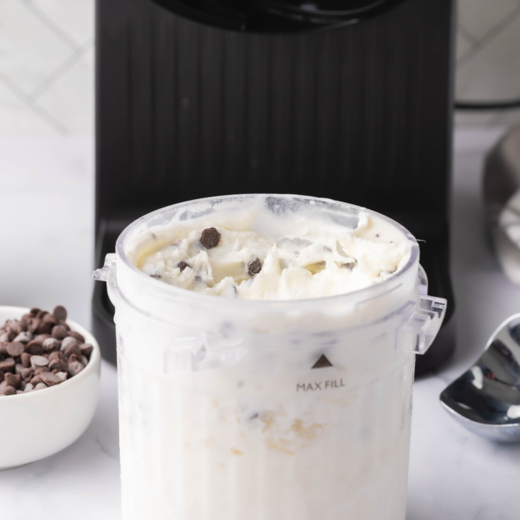 Bowl of homemade Ninja Creami stracciatella gelato with thin chocolate flakes throughout.