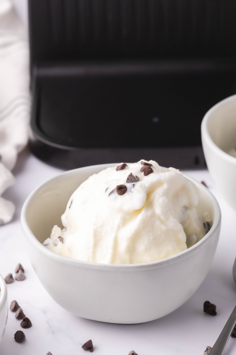 Creamy Ninja Creami stracciatella gelato in a bowl with chocolate flakes throughout