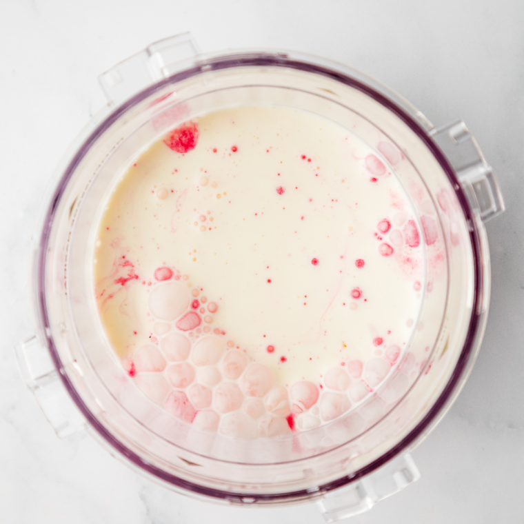 Frozen gelato base inserted into Ninja Creami machine ready to process on Gelato setting.