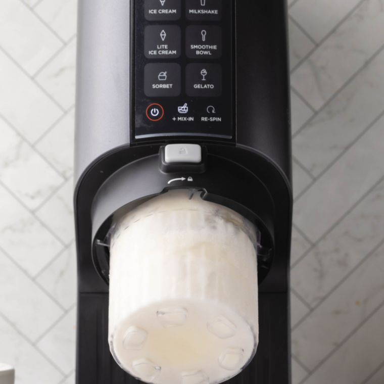 Ninja Creami pint filled with gelato base placed in freezer to set.