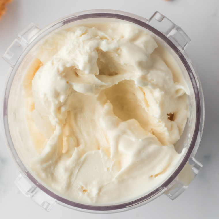 Scooping creamy gelato into bowl with smooth texture.