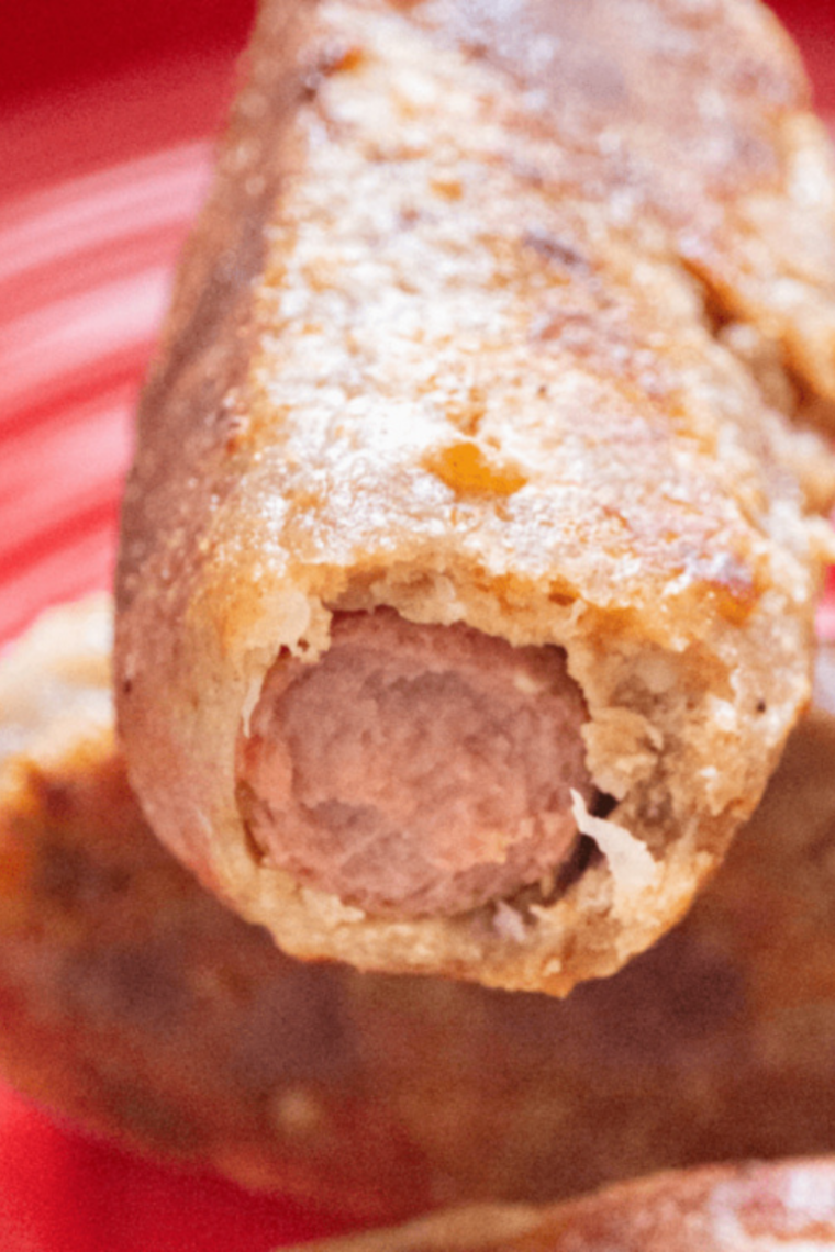 Air fryer keto corn dogs with a crispy low-carb coating on a serving plate, ready to eat.