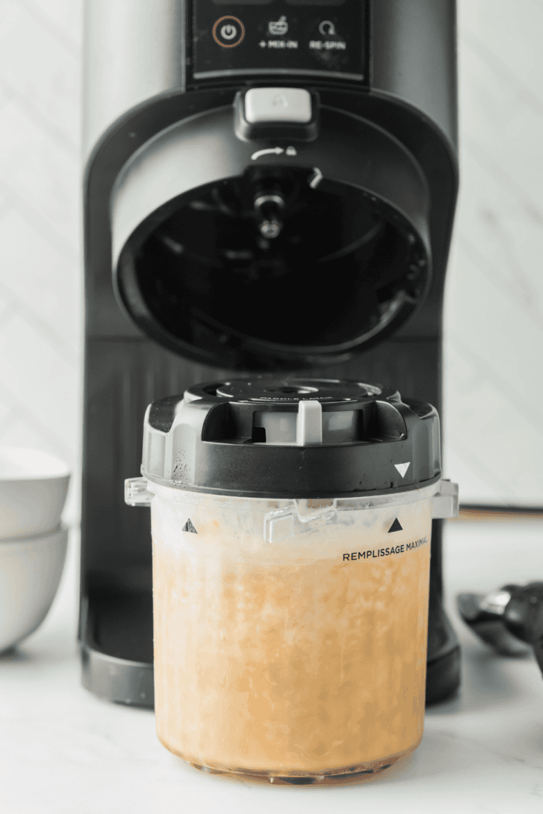 Ninja Creami pint container with White Chocolate Mocha mixture frozen solid in the freezer.