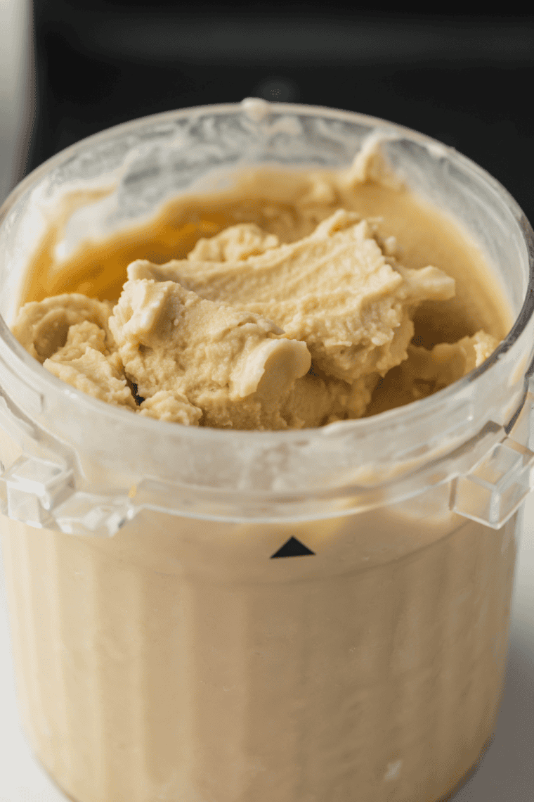 Glass of creamy Ninja Creami White Chocolate Mocha Frappuccino with whipped cream and chocolate topping.