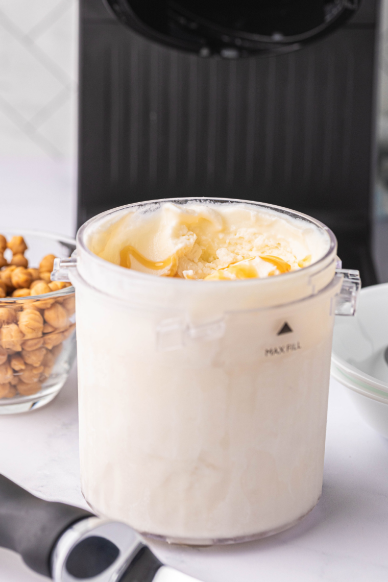 Creamy Ninja Creami salted caramel gelato scooped into bowl with caramel drizzle and sea salt flakes