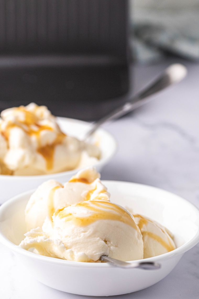 Smooth Ninja Creami salted caramel gelato in a bowl with caramel drizzle and sea salt flakes