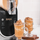 Frozen Irish coffee slush made in a Ninja Slushi machine, topped with whipped cream and served in a clear glass.