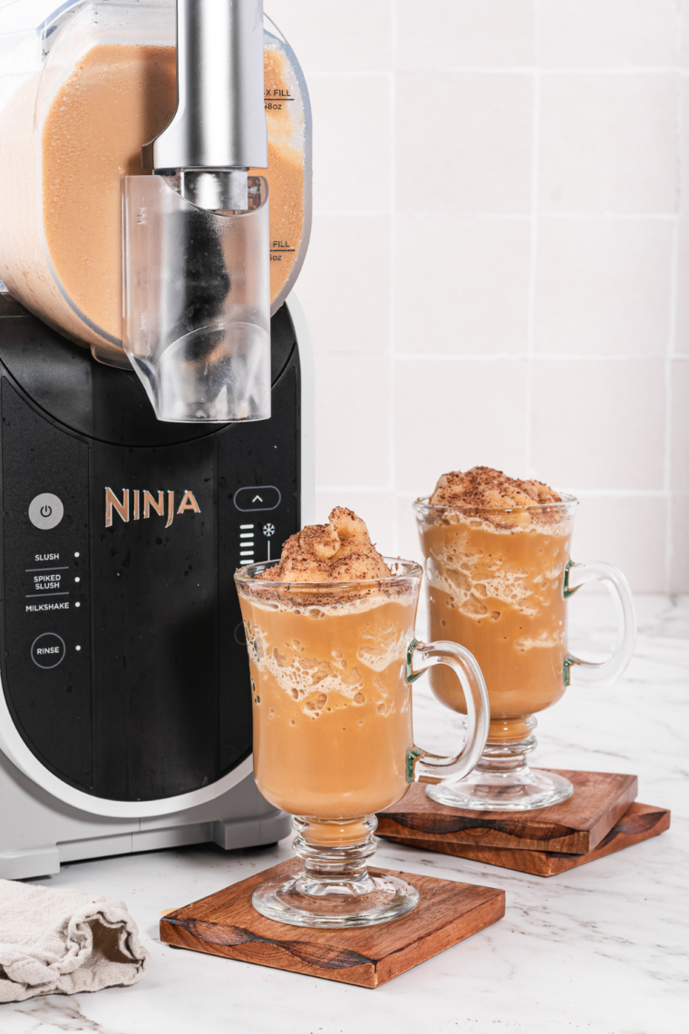 Frozen Irish coffee poured into chilled glasses, topped with whipped cream and chocolate shavings.