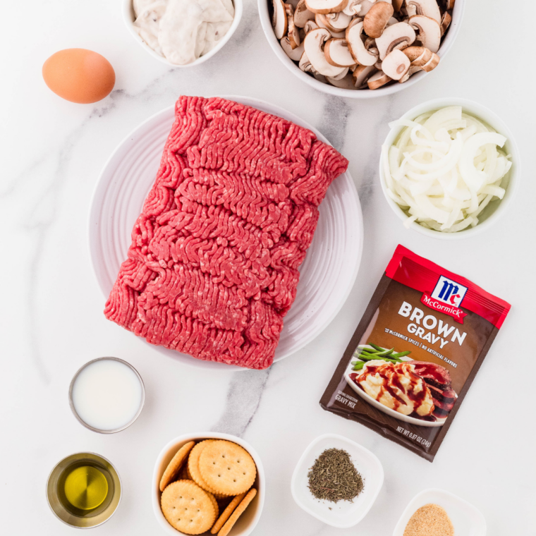 Ingredients needed for Slow Cooker Salisbury Steak With Cream Of Mushroom Soup on kitchen table.