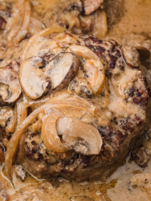 Slow Cooker Salisbury Steak with Cream of Mushroom Soup served on a plate, topped with creamy mushroom gravy and garnished with fresh parsley.