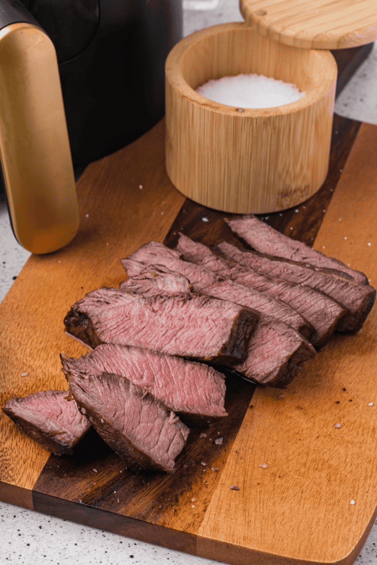 Glass bowl with 3-ingredient steak marinade, ready to coat raw steaks.