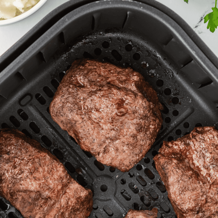 Steak being grilled, broiled, or pan-seared until cooked to desired doneness.