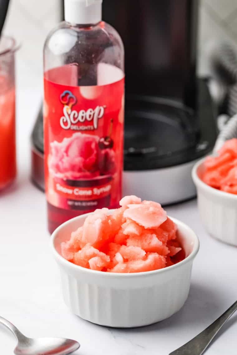 Bright red Cherry Italian Ice in a clear glass, smooth icy texture, garnished with fresh cherries.
