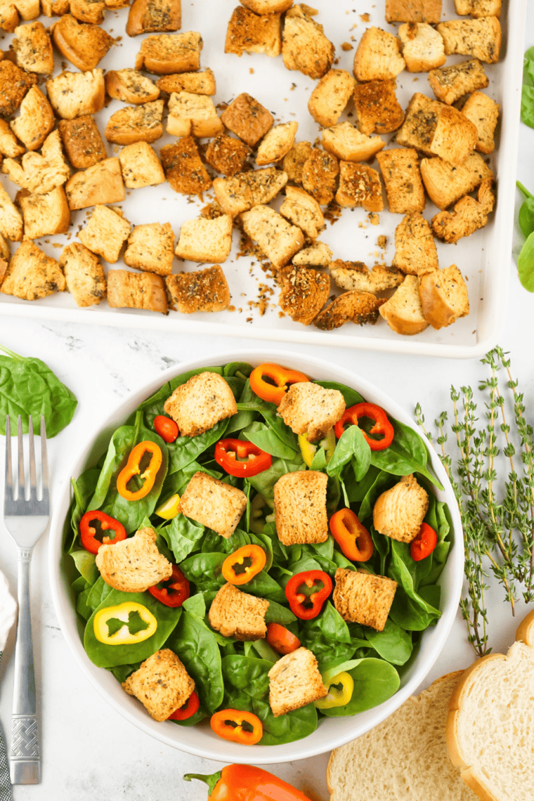 Copycat Bonefish Grill House Salad with romaine, iceberg, cherry tomatoes, cucumbers, red onions, shredded carrots, olives, croutons, and Parmesan cheese, tossed in house-style dressing.