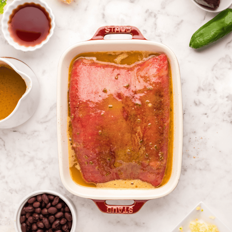 Dry spices being added to a large mixing bowl to make cowboy butter seasoning.