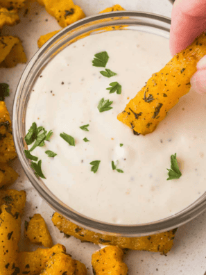 Jar of homemade Copycat Kinder&rsquo;s Sweet Heat Seasoning with a small spoon, showing reddish-brown spice blend.