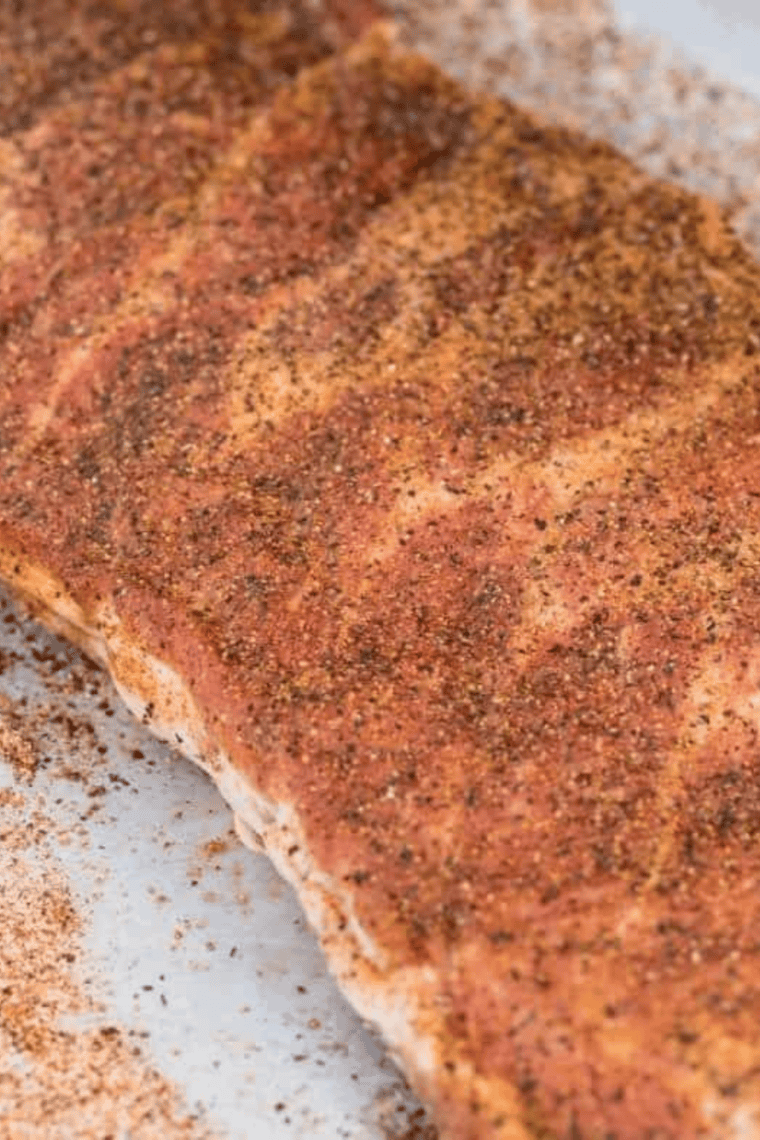 Homemade Kinder&rsquo;s The Steak Blend being whisked and sprinkled over steaks, burgers, and vegetables