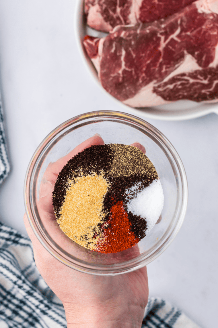Mixing spices together to create Montreal steak seasoning blend.