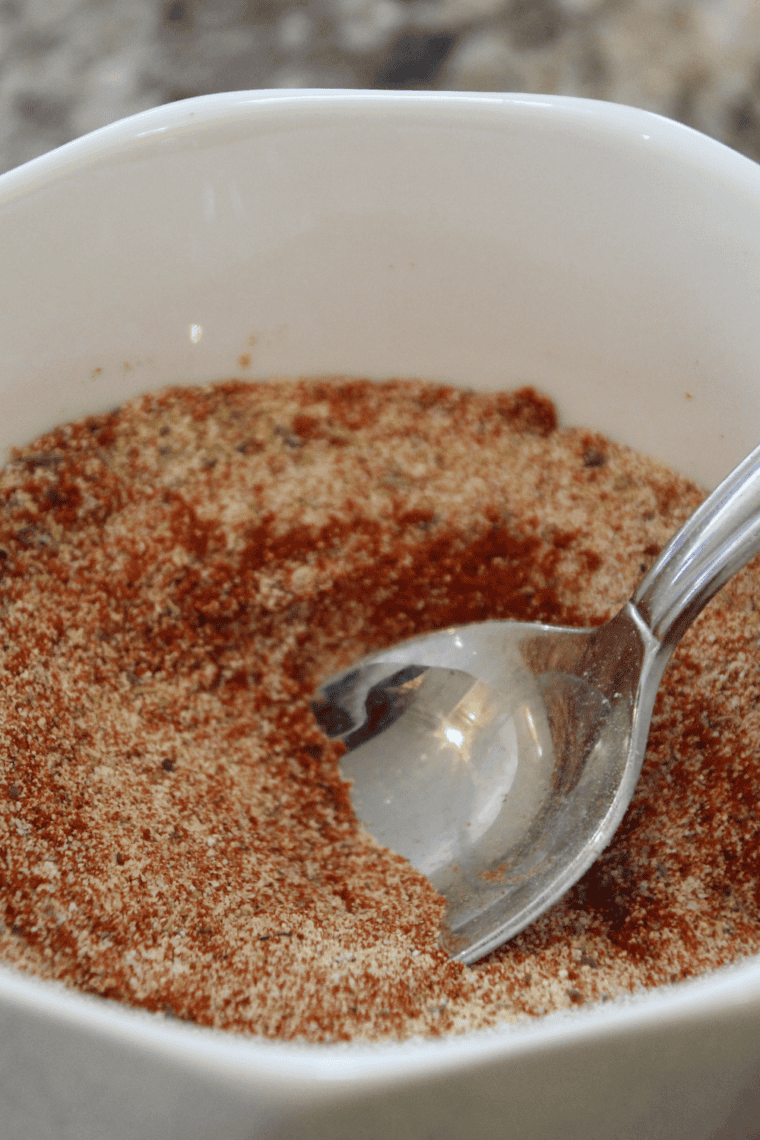 Tasting homemade steak seasoning and adjusting spices if needed.