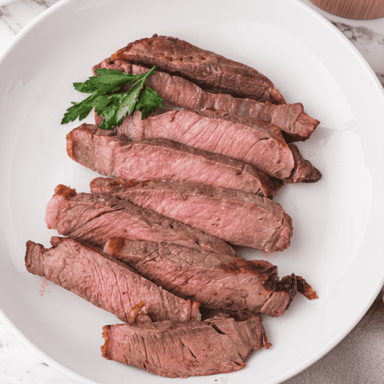 Small bowl of homemade Montreal steak seasoning with coarse spices and herbs.