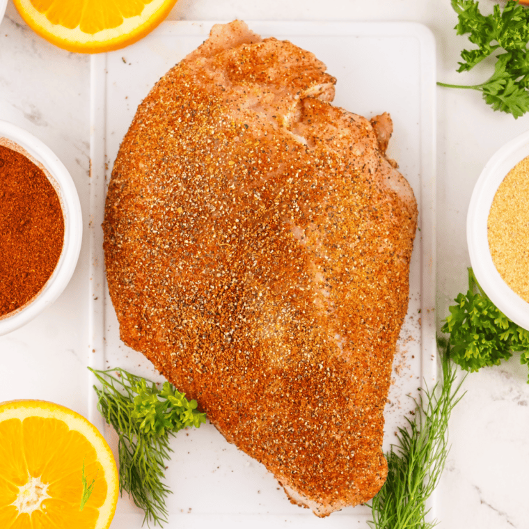 Sprinkling Copycat Tony Chachere&rsquo;s Creole Seasoning on meats, seafood, and vegetables.