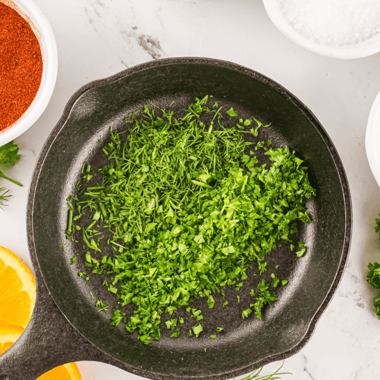 Measuring paprika, cayenne, salt, garlic powder, onion powder, black pepper, oregano, and thyme for Creole seasoning.