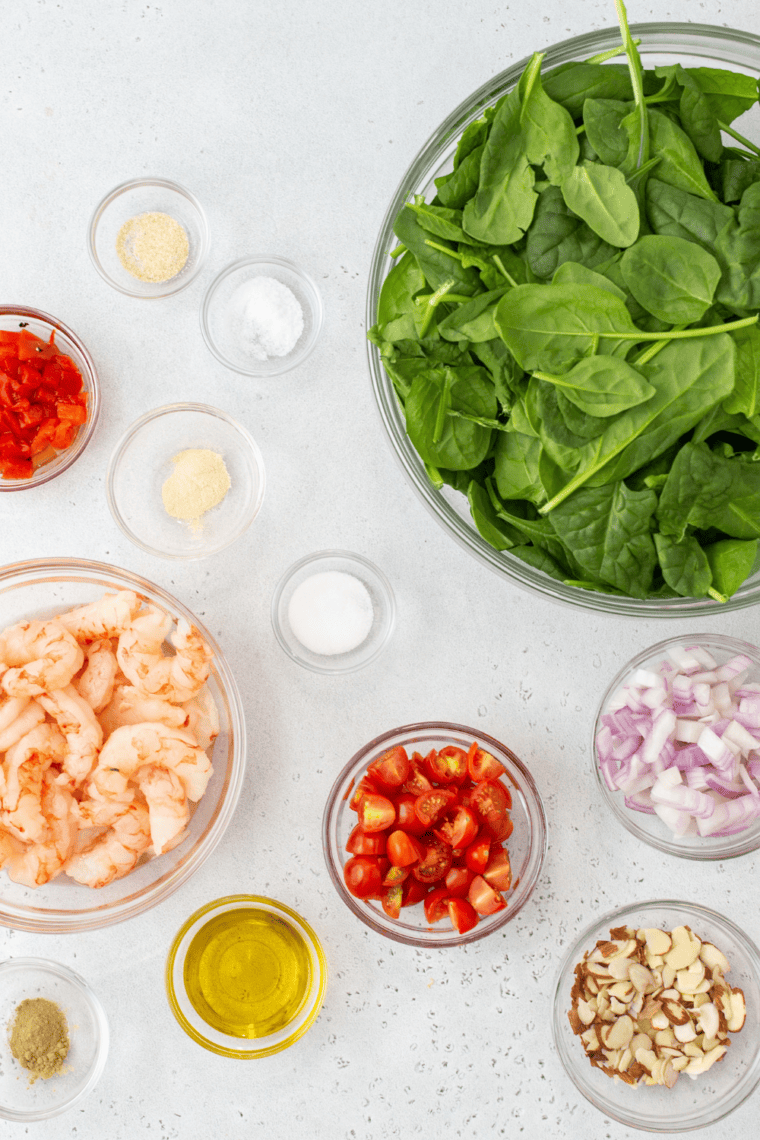 Ingredients needed for Easy Air Fryer Shrimp and Spinach Salad on kitchen table.