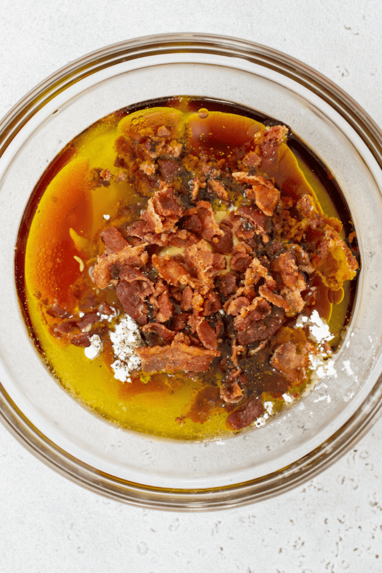 Small bowl of salad dressing being whisked smooth and creamy.