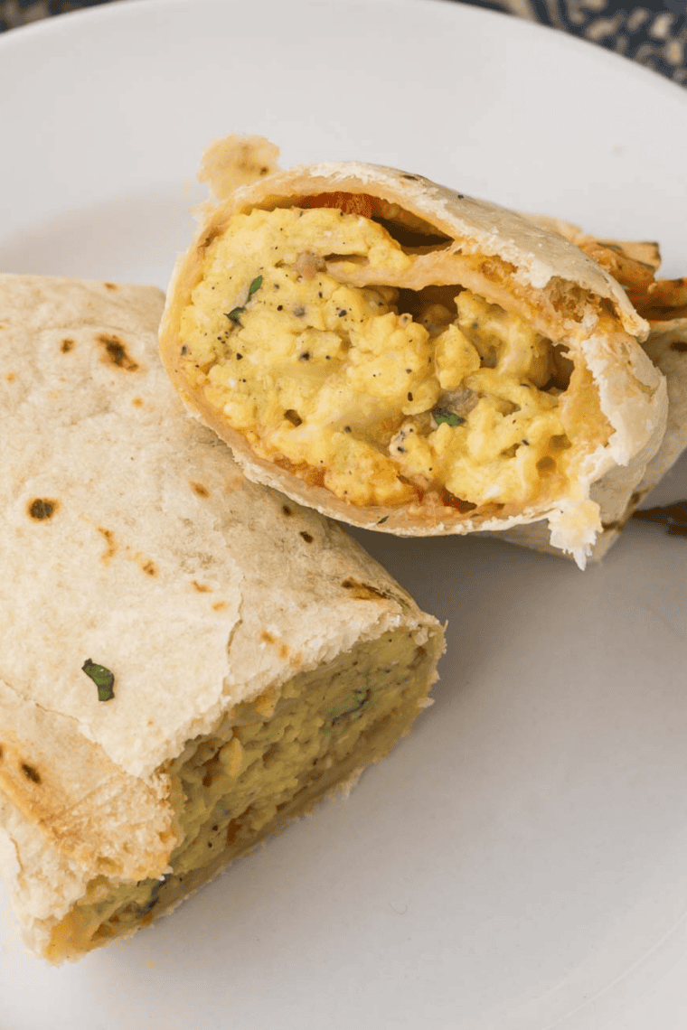 Golden air fryer Tex-Mex breakfast burritos filled with scrambled eggs, cheese, and chorizo