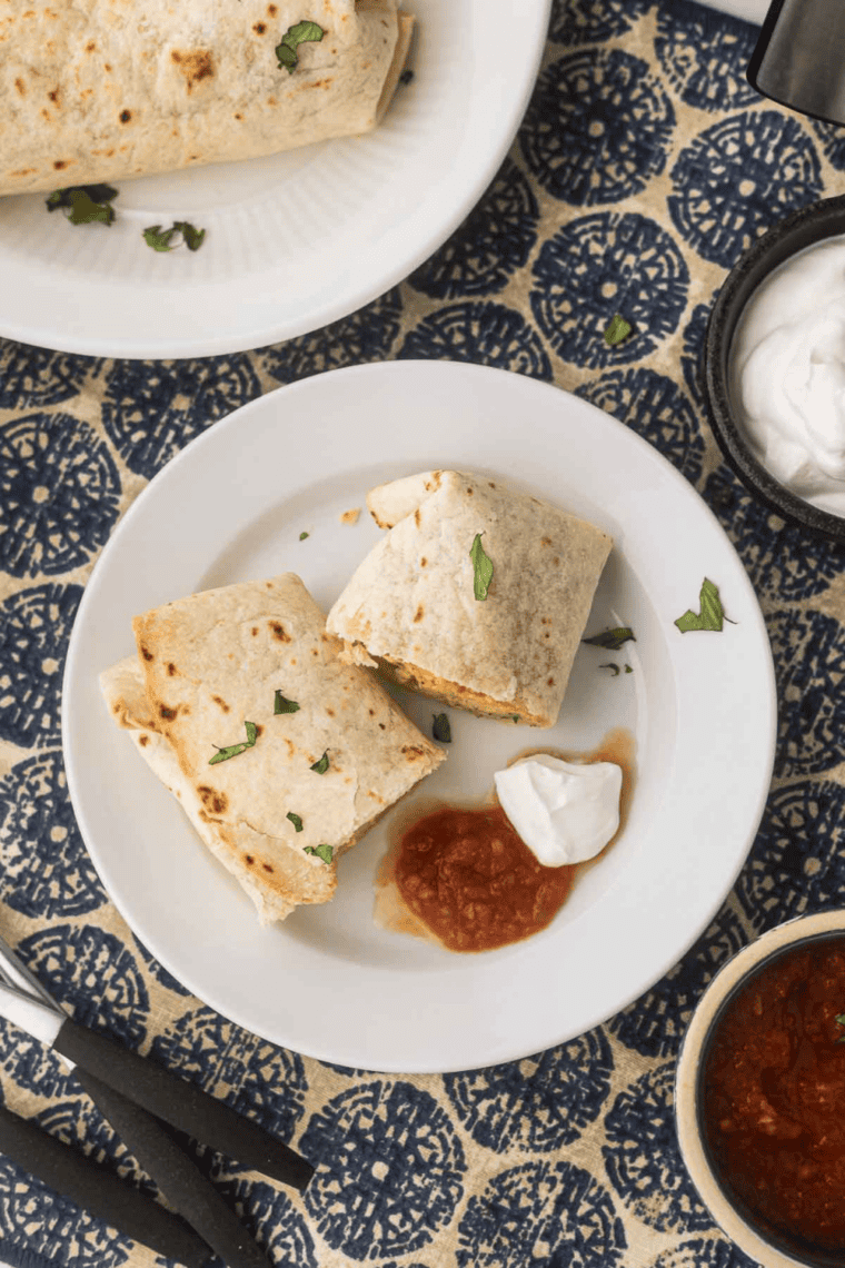 Golden air fryer Tex-Mex breakfast burritos filled with eggs, cheese, and savory ingredients