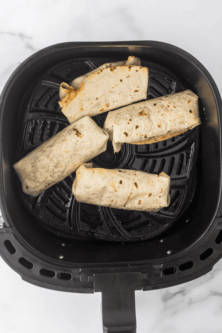 Tex-Mex breakfast burritos served warm with salsa, sour cream, and guacamole.