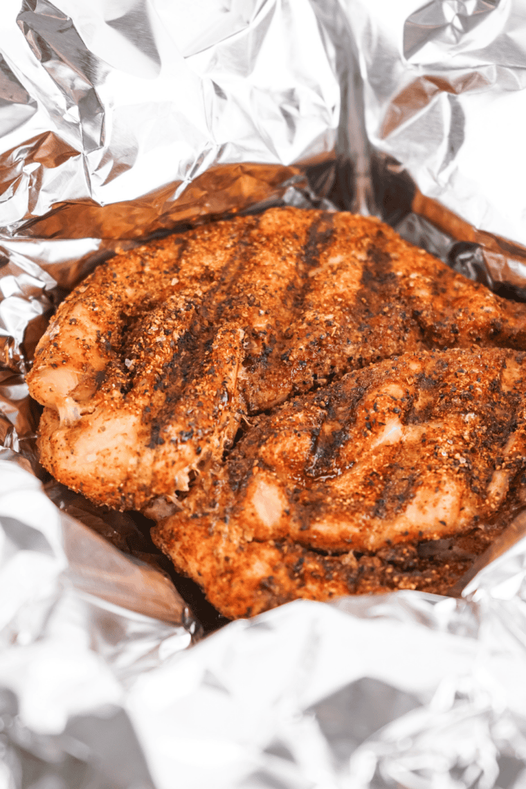 Smoking seasoned turkey breast until internal temperature reaches 165&deg;F.