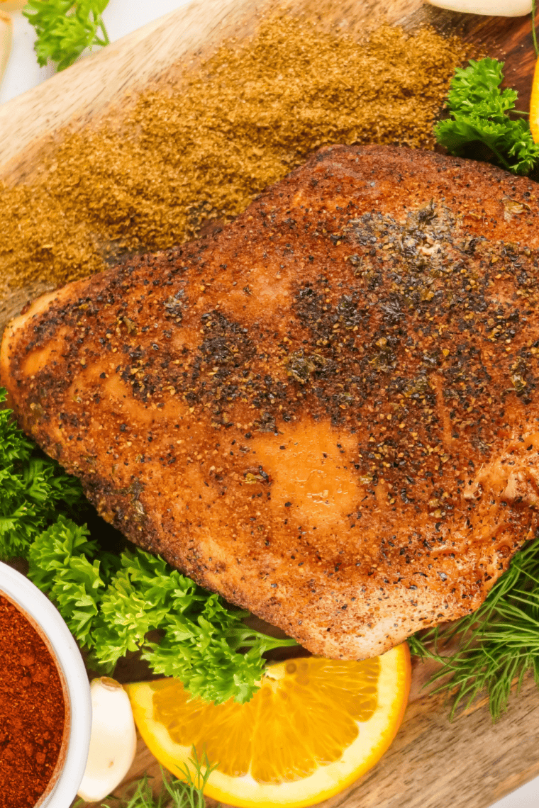 Juicy, smoked Cajun turkey breast sliced and arranged on a serving platter.