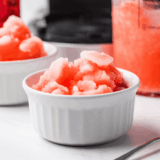 Bright red cherry Italian ice scooped into a glass bowl, smooth icy texture made in the Ninja Creami.