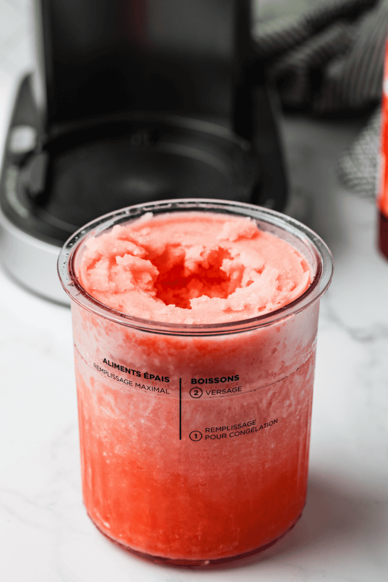 Smooth, bright red Cherry Italian Ice served in a glass, ready to eat.