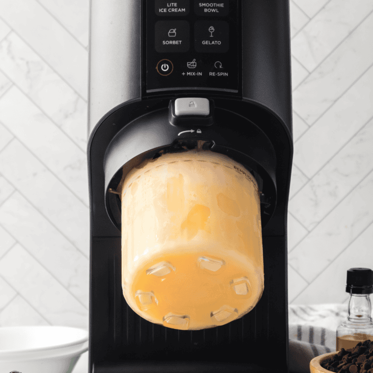 Frozen gelato pint being processed in Ninja Creami to create smooth gelato.