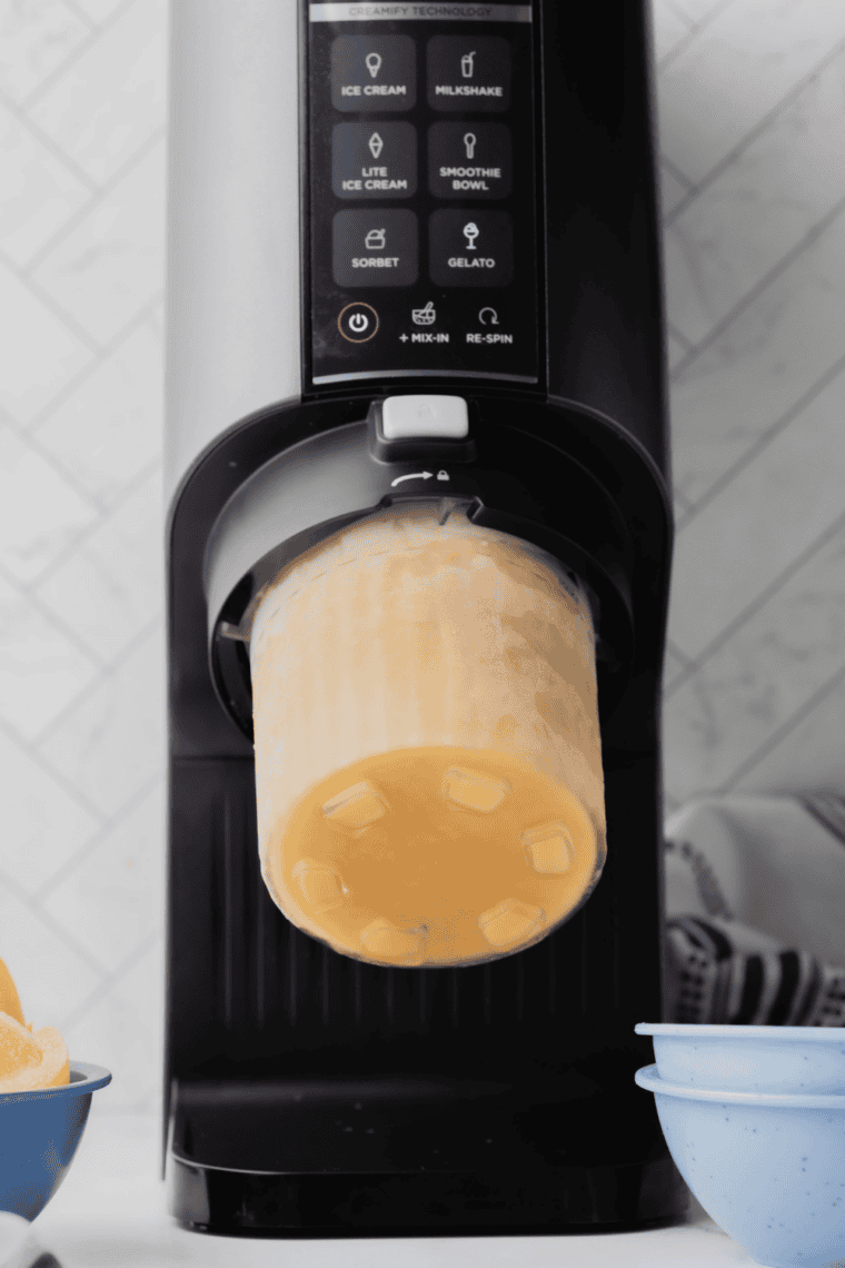 "Sweet cream mixture poured into Ninja Creami pint container before freezing"