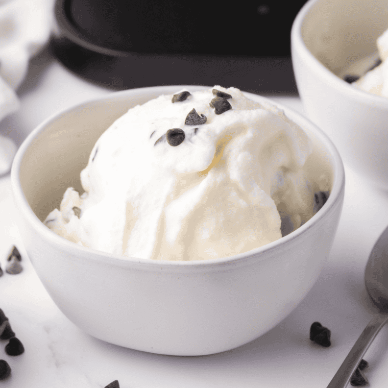 Creamy Ninja Creami Fior Di Latte sweet cream gelato in a bowl with berries and mint, smooth and scoopable