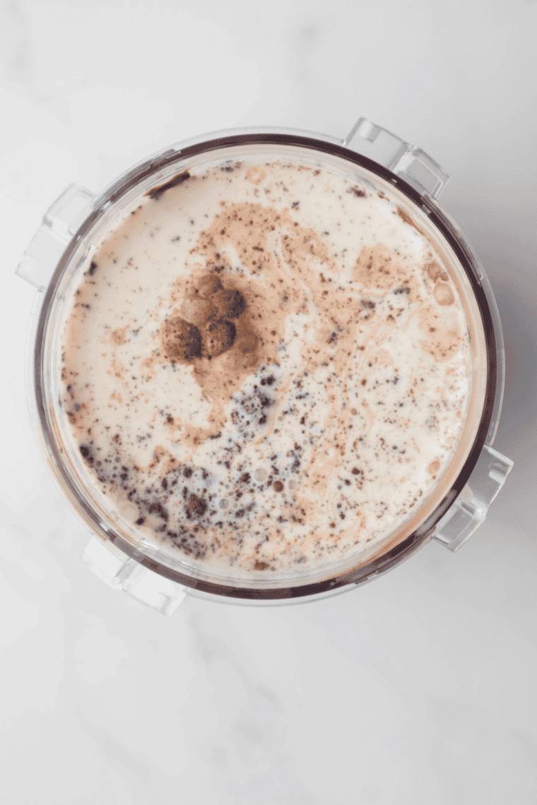 Combining whole milk, heavy cream, sugar, hazelnut paste, and vanilla extract in a bowl for gelato base.