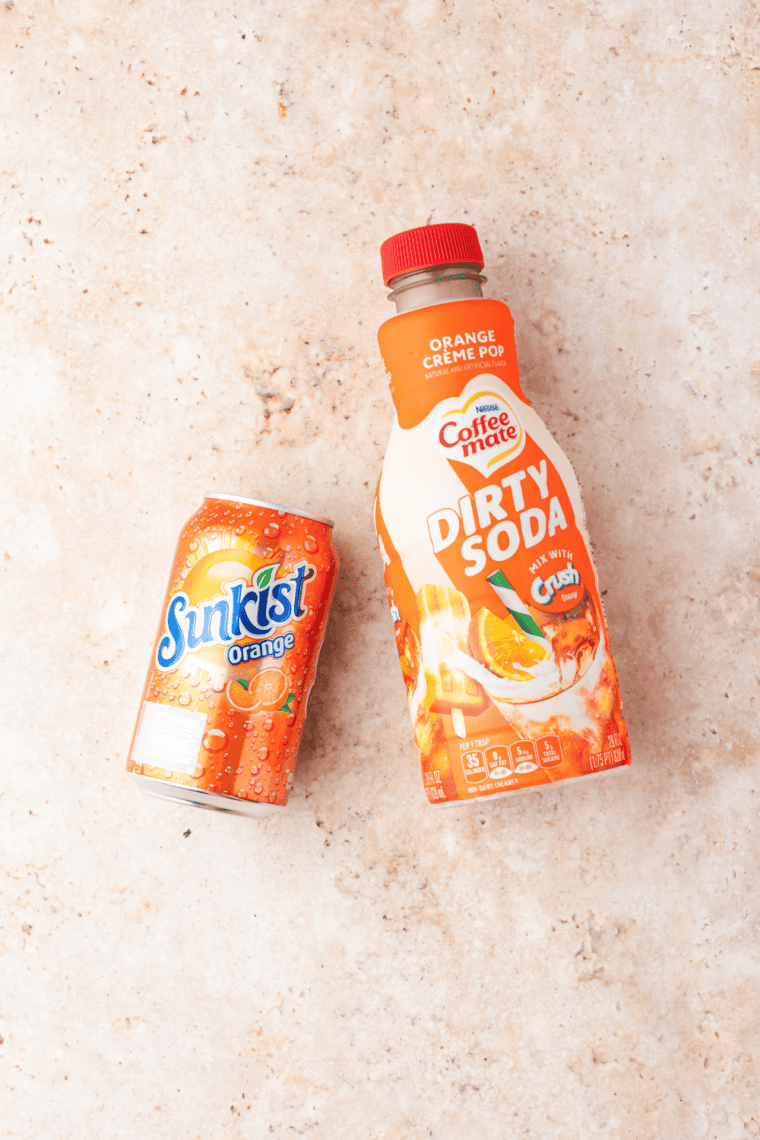 Ingredients needed for Easy Ninja Slushi Frozen Dirty Orange Soda Recipe on kitchen table.