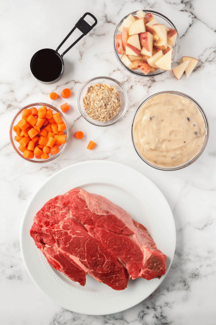 Ingredients needed for Easy Slow Cooker Beef Sirloin Tip Roast With Gravy on kitchen table.
