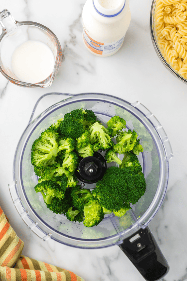 Blanching broccoli in salted water then shocking in cold water, pur&eacute;eing with cream and milk.