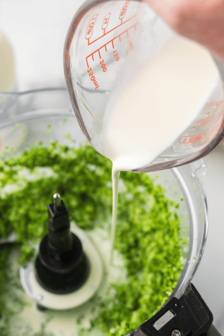 Saut&eacute;ing chopped garlic in olive oil and butter, adding broccoli cream mixture, seasoning with salt, pepper, and garlic powder.