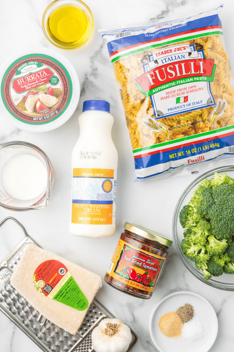 Ingredients needed for Easy Trader Joe's Broccoli Fusilli Pasta Bake on kitchen table.