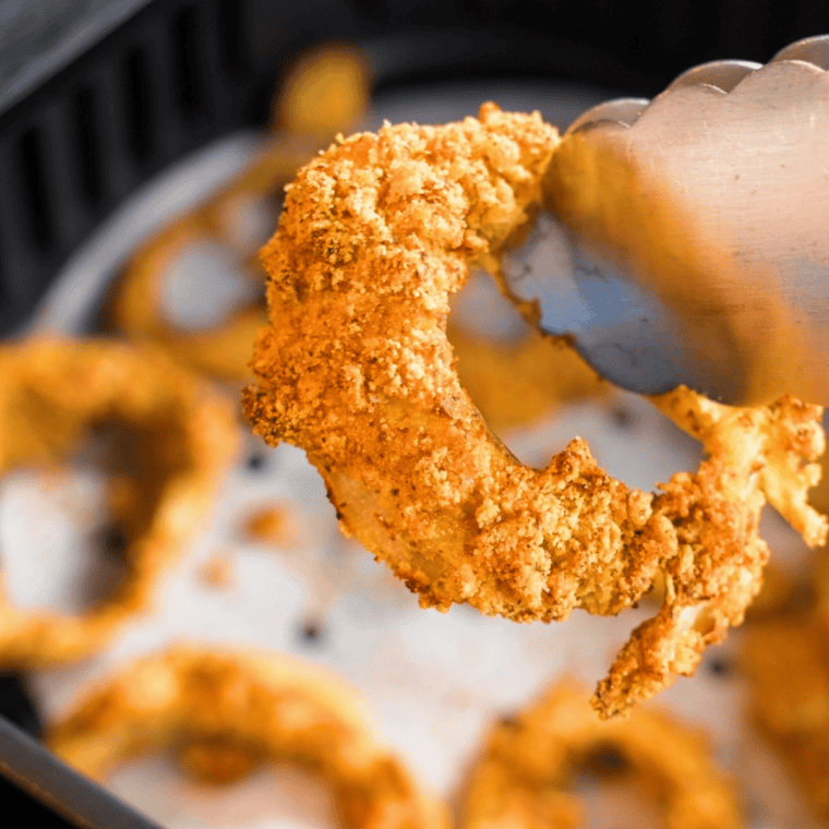 Close up of Long John Silver’s Onion Rings Recipe in the air fryer basket.