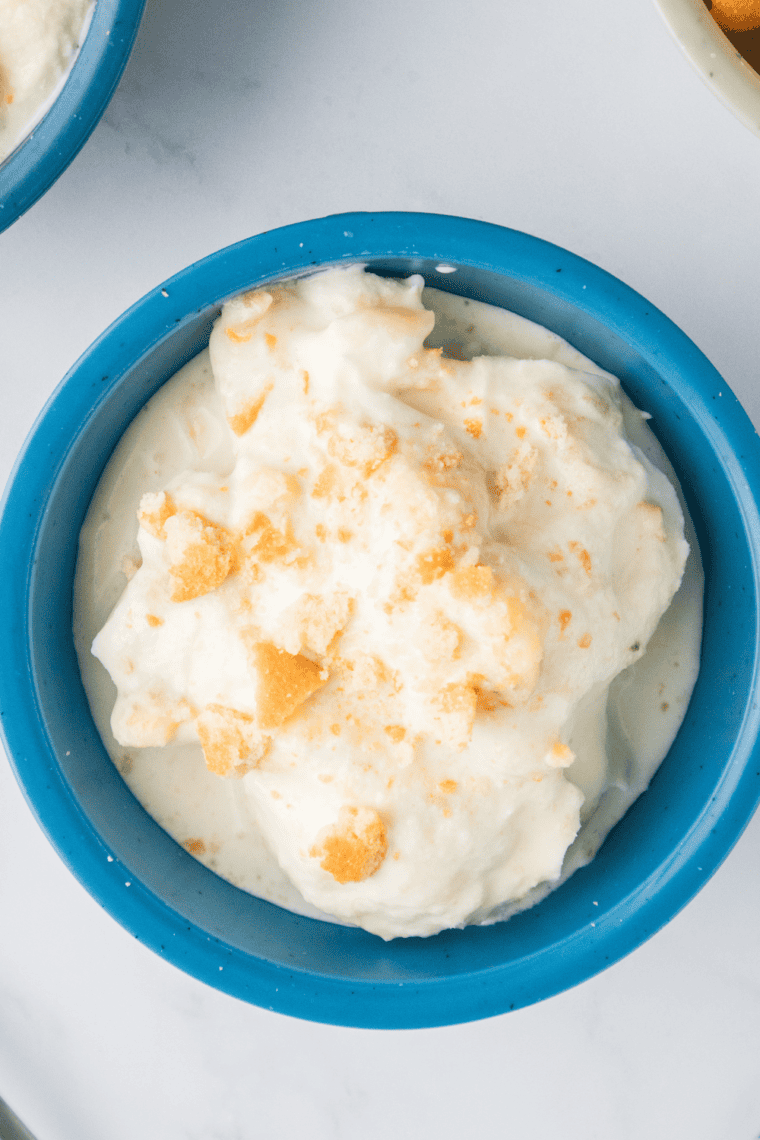 Scooping creamy Nutty Coconut ice cream into bowls ready to serve.