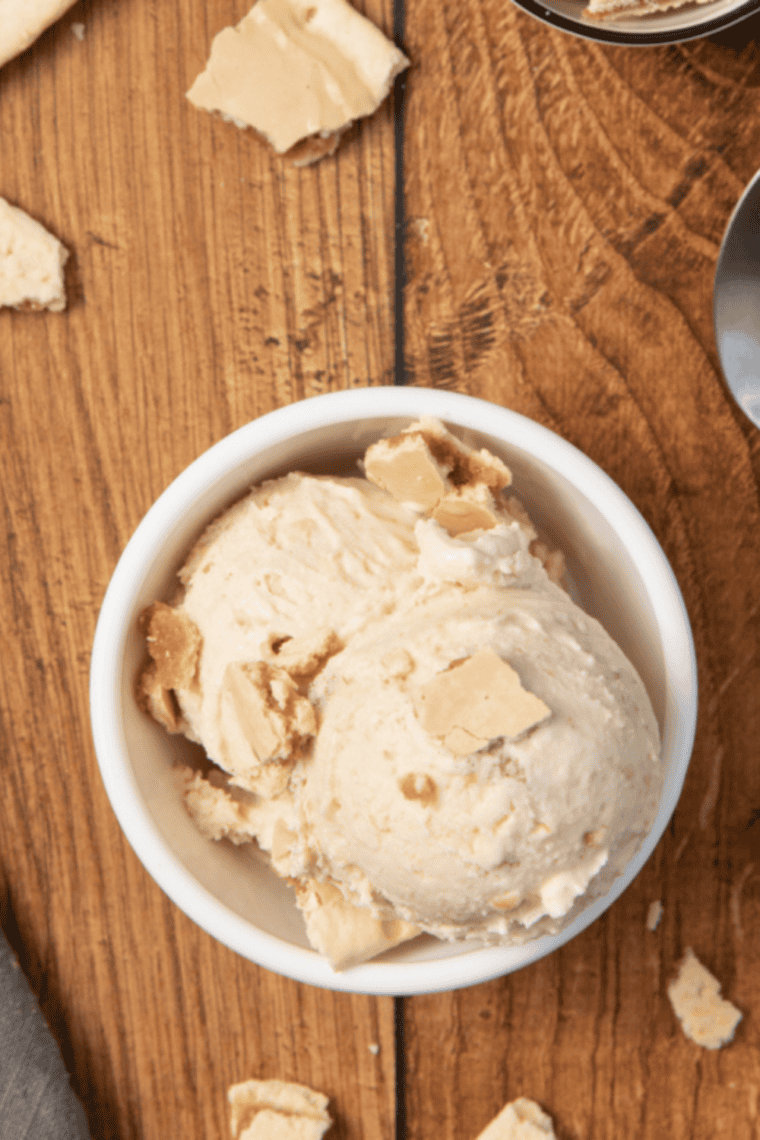 Serve and Enjoy: Scooping smooth almond gelato into bowls or cones for serving.