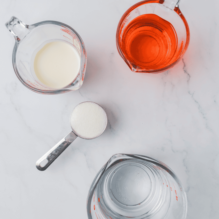 Ingredients needed for Ninja Creami Orange Creamcicle Italian Ice on kitchen table.