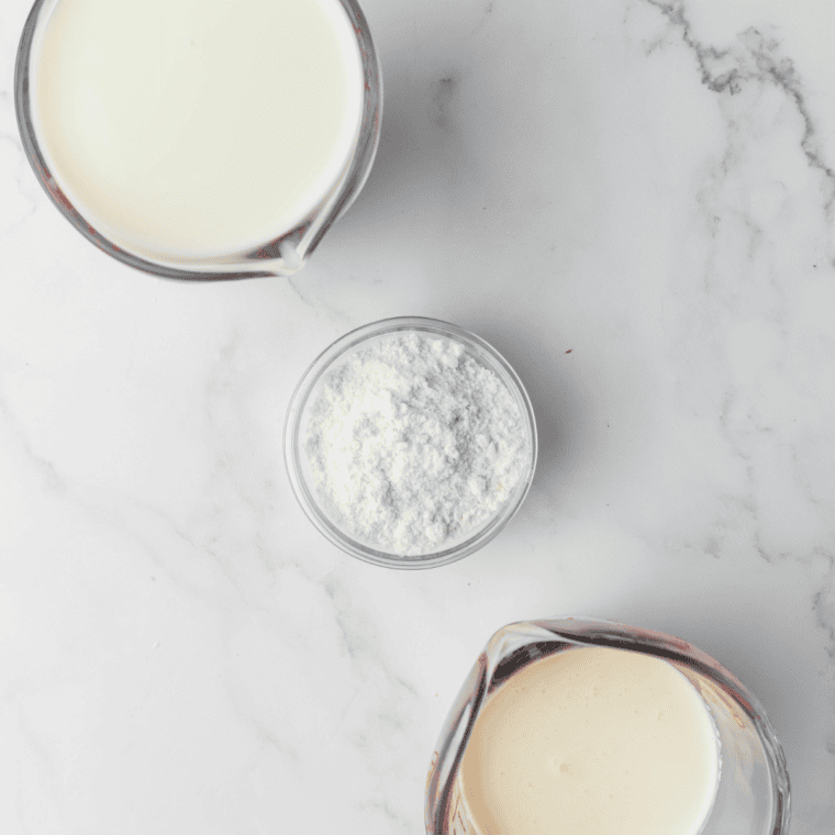 Ingredients needed for Ninja Slushie Shamrock Shake Recipe on kitchen table.