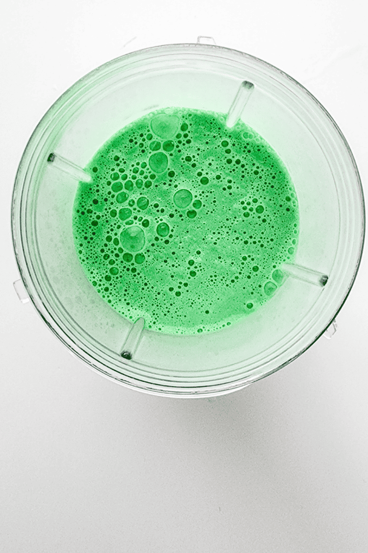 Adding milk, condensed milk, peppermint extract, and green coloring to Ninja blender.
